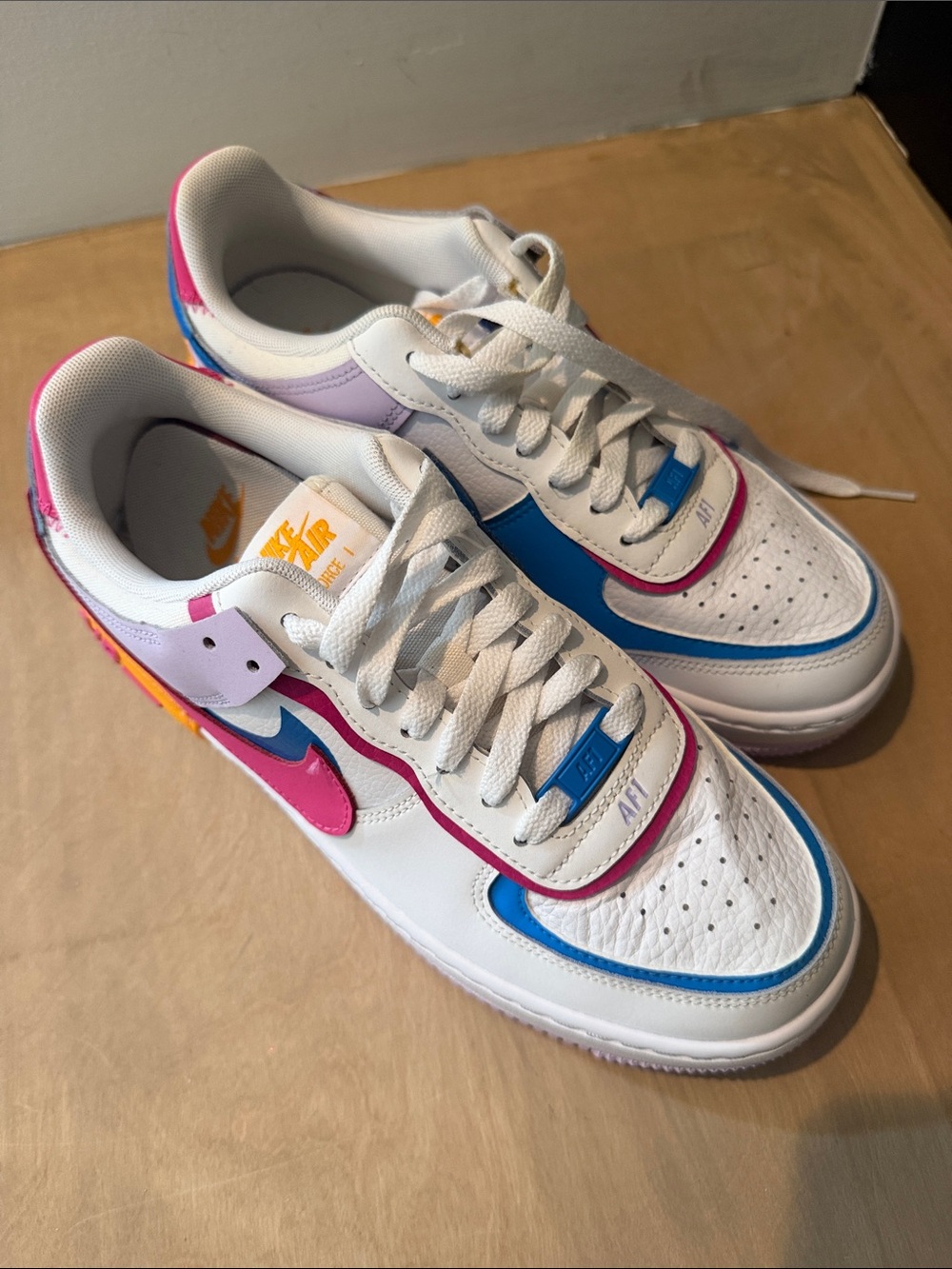 Nike White Low-Top Sneakers with Blue, Pink, Purple & Orange Accents